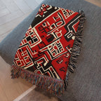 Kök Stüdyo Moroccan Berber-inspired woven throw blanket in red, black, and cream with geometric pattern and fringe.