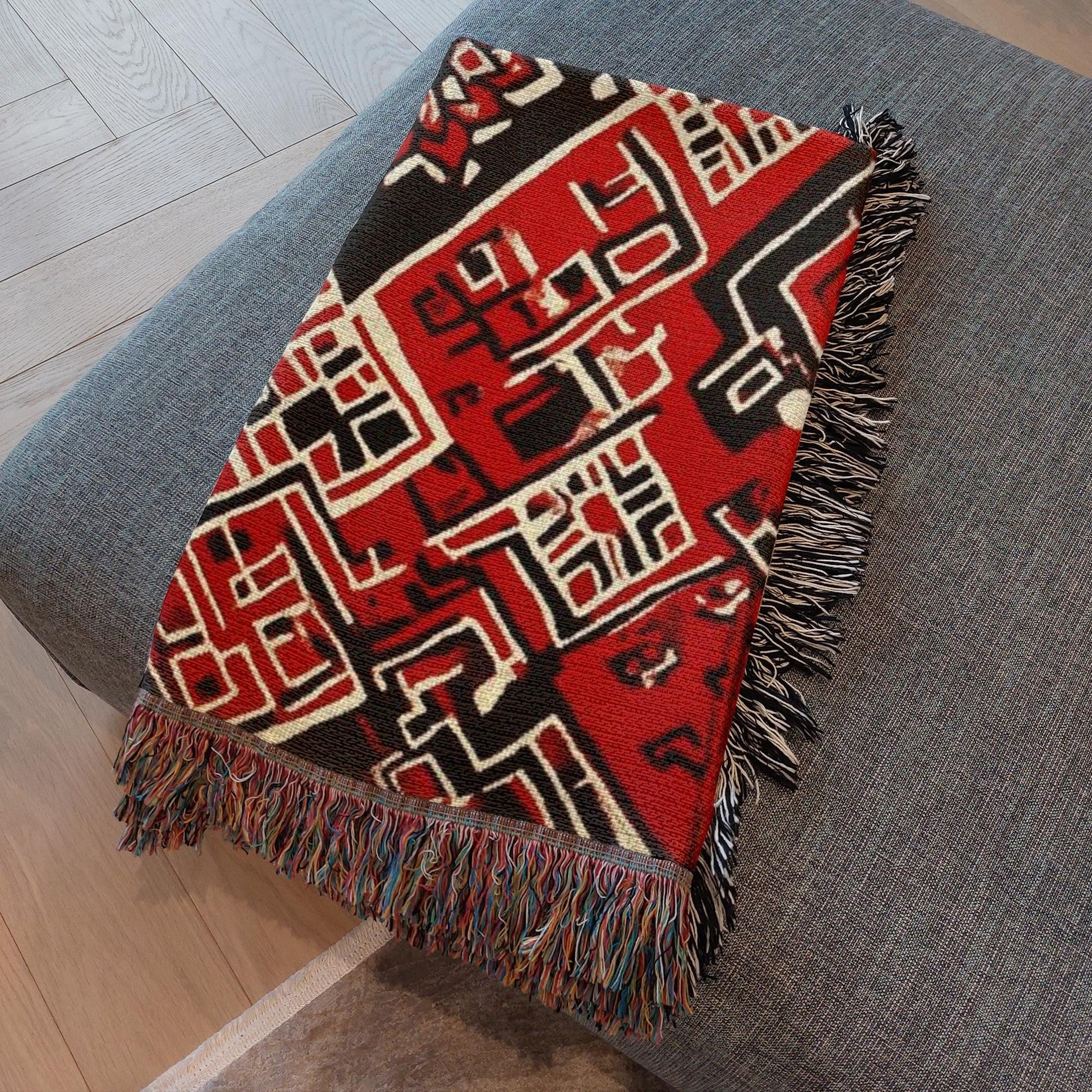 Kök Stüdyo Moroccan Berber-inspired woven throw blanket in red, black, and cream with geometric pattern and fringe.