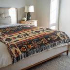 Kök Stüdyo Seminoles woven throw blanket with Native American geometric patterns in cream, black, red, gold, and turquoise. Pure cotton jacquard with fringe.