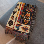Kök Stüdyo Seminoles woven throw blanket with Native American geometric patterns in cream, black, red, gold, and turquoise. Pure cotton jacquard with fringe.