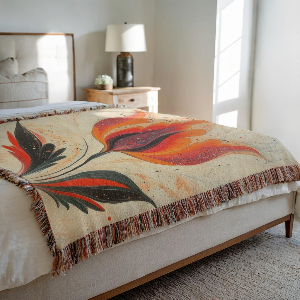 Kök Stüdyo woven throw blanket with a vibrant orange and red tulip design inspired by Turkish marbling art, made of 100% cotton.
