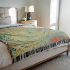 Kök Stüdyo woven cotton throw blanket with abstract pastel marbling pattern in yellow, teal, and coral.