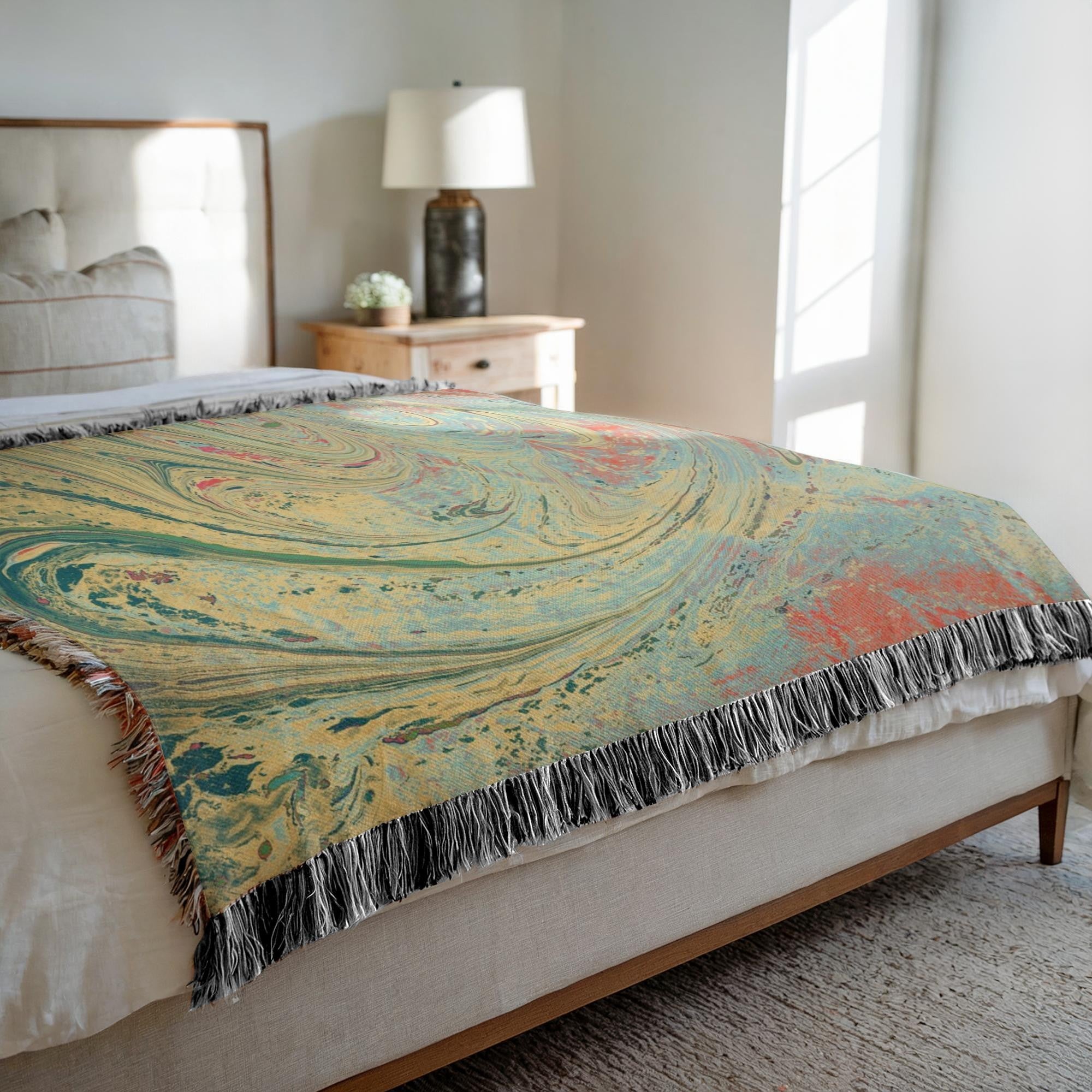 Kök Stüdyo woven cotton throw blanket with abstract pastel marbling art in yellow, teal, and coral.