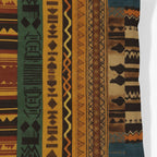 Kök Stüdyo African Ndelebe pattern woven throw pillow with geometric designs in rust, green, yellow, and brown tapestry fabric.