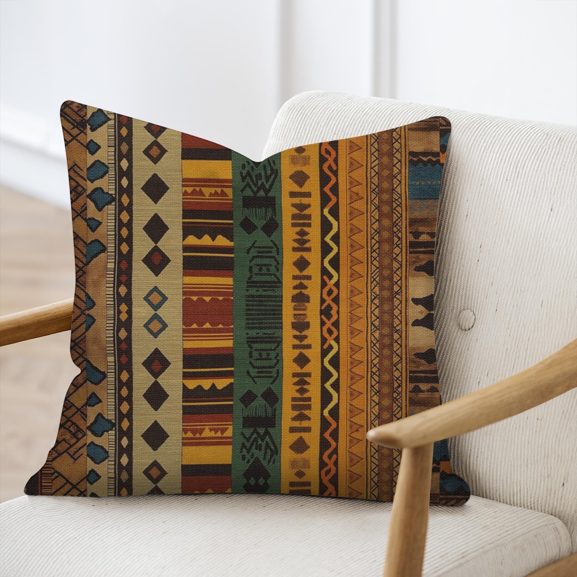 Kök Stüdyo African Ndelebe pattern woven throw pillow with geometric designs in brown, yellow, green, and blue tapestry fabric.