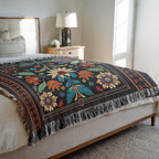 Kök Stüdyo woven cotton blend blanket with vibrant floral Chippewa art in red, yellow, blue, and green on black.