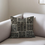 Kök Stüdyo African mud cloth inspired woven throw pillow with tufted geometric pattern in black and beige.