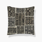 Kök Stüdyo African Mud Cloth inspired woven throw pillow with black and beige geometric patterns and tufted texture.
