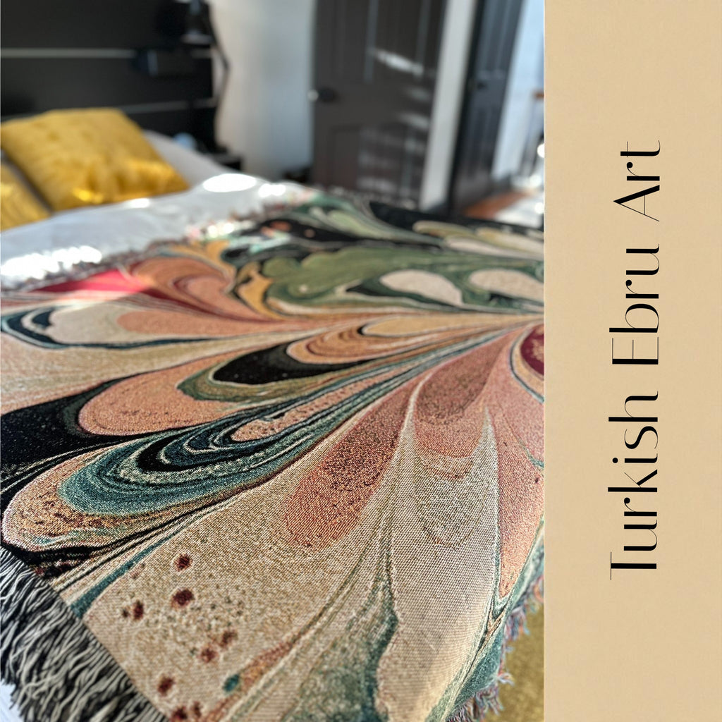 Kök Stüdyo woven throw blanket with a colorful abstract Turkish marbling design in cotton.