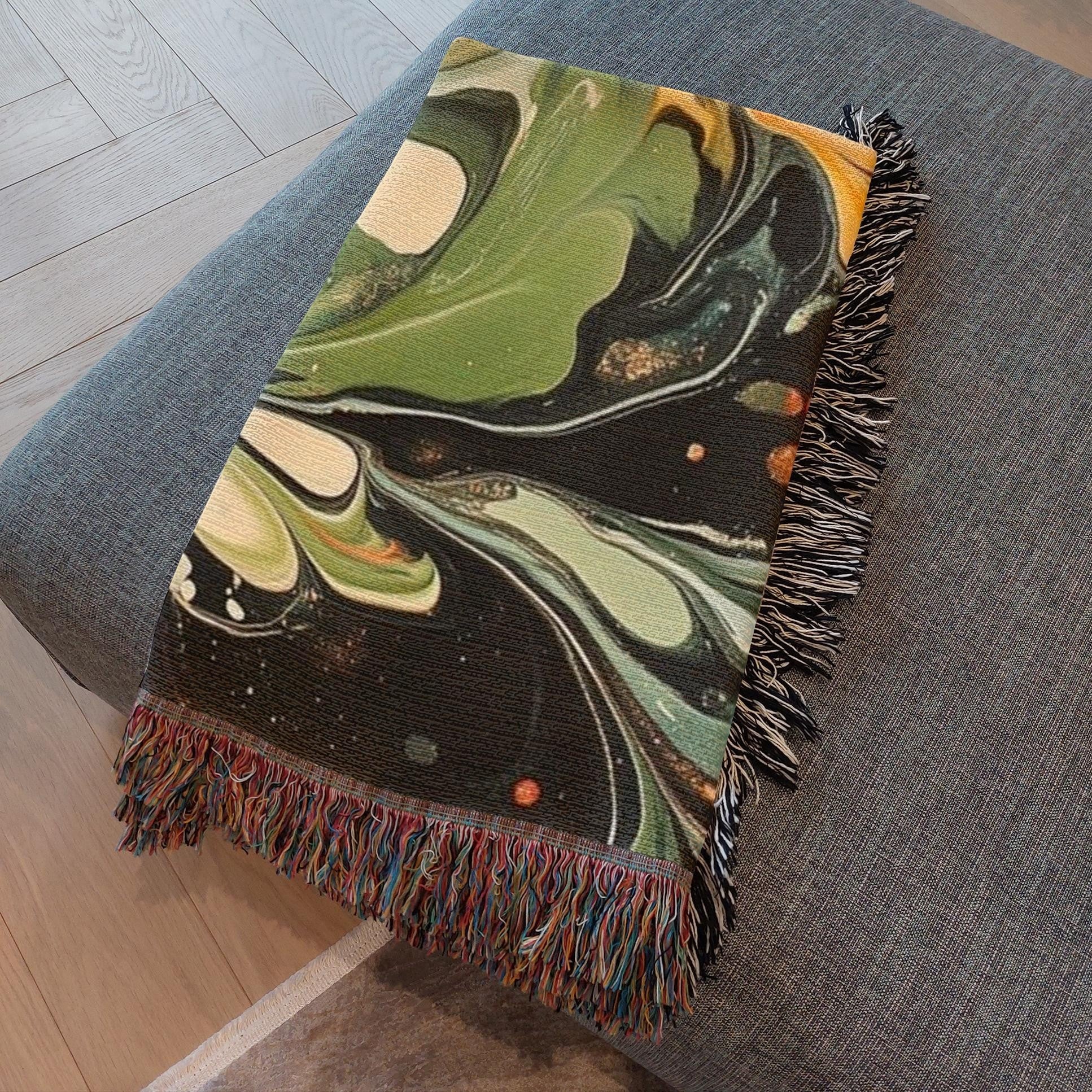 Kök Stüdyo abstract green and black marbling woven cotton throw blanket with colorful fringe.
