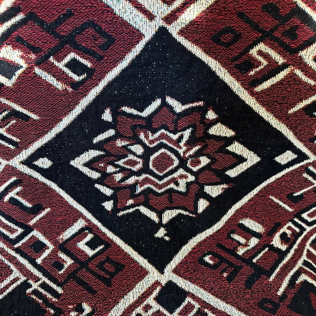 Kök Stüdyo Moroccan Berber-inspired woven blanket in deep red, black, and cream geometric pattern. Textured throw.