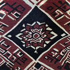 Kök Stüdyo Moroccan Berber-inspired woven blanket in deep red, black, and cream geometric pattern. Textured throw.