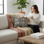 Kök Stüdyo African Mud Cloth inspired woven pillow with black and white geometric pattern, tufted texture.